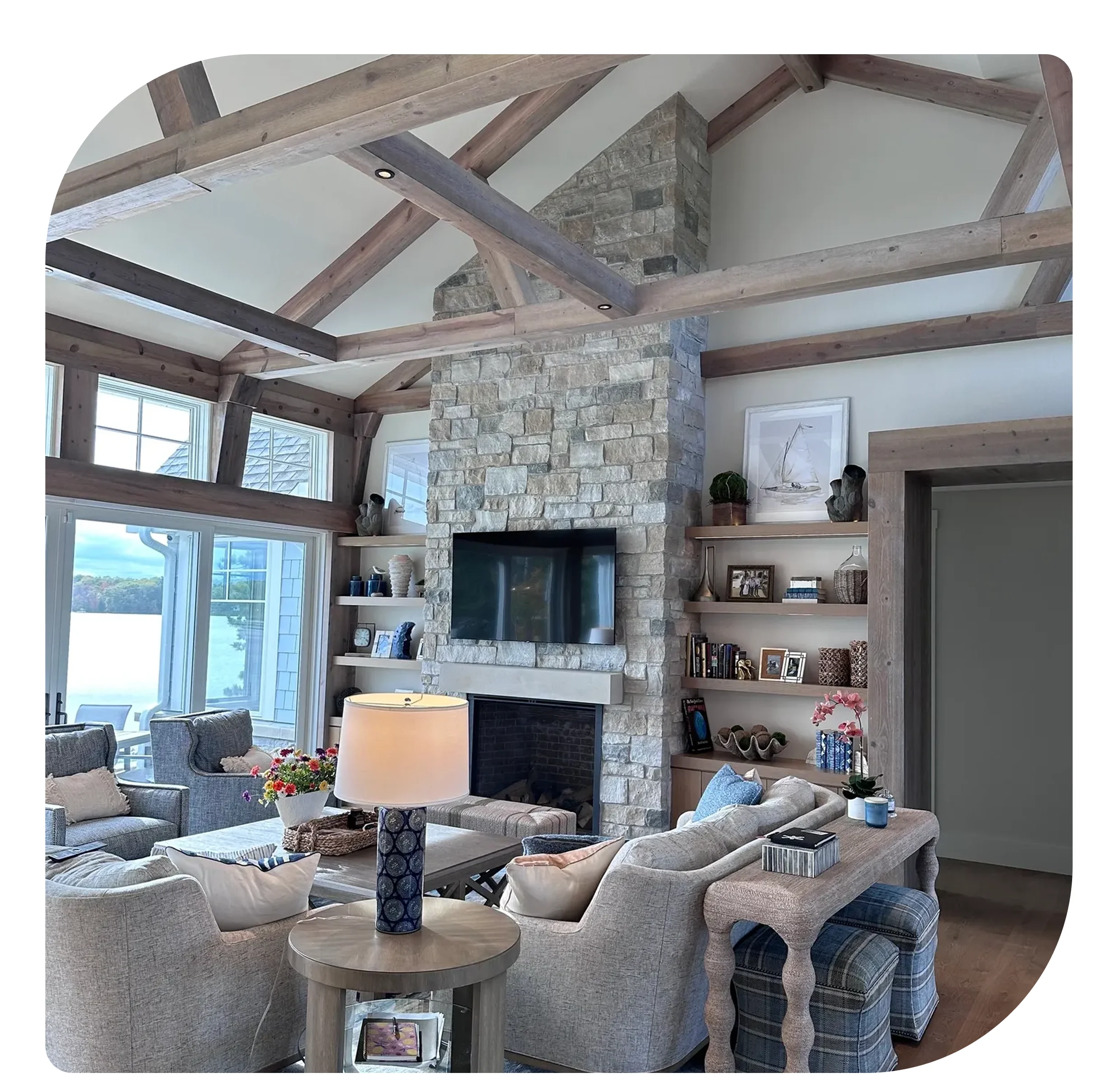 Cozy living room with stone fireplace and exposed beams.